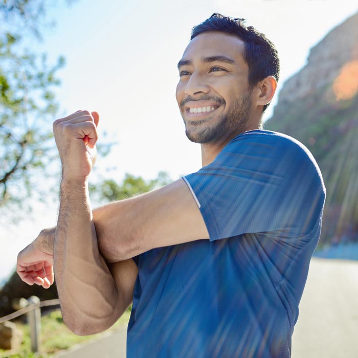 Man stretching and happy after a successful pain relief treatment in Maryland