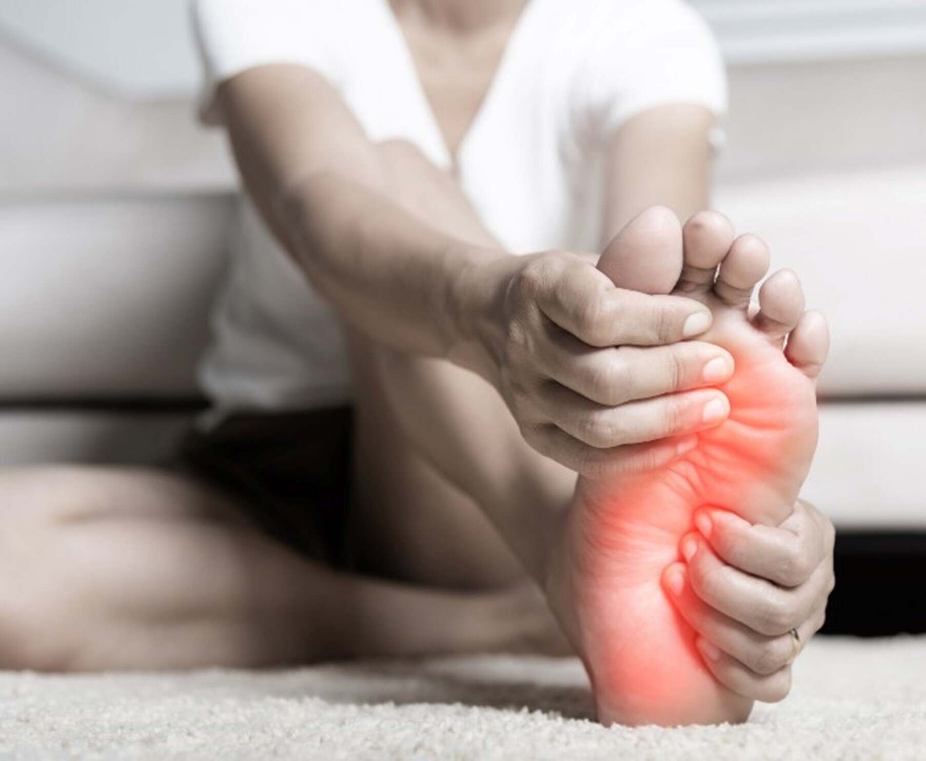 A woman experiencing pain in her foot while at her home in Maryland