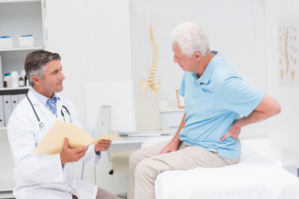 Man with backpain in consultation with doctor