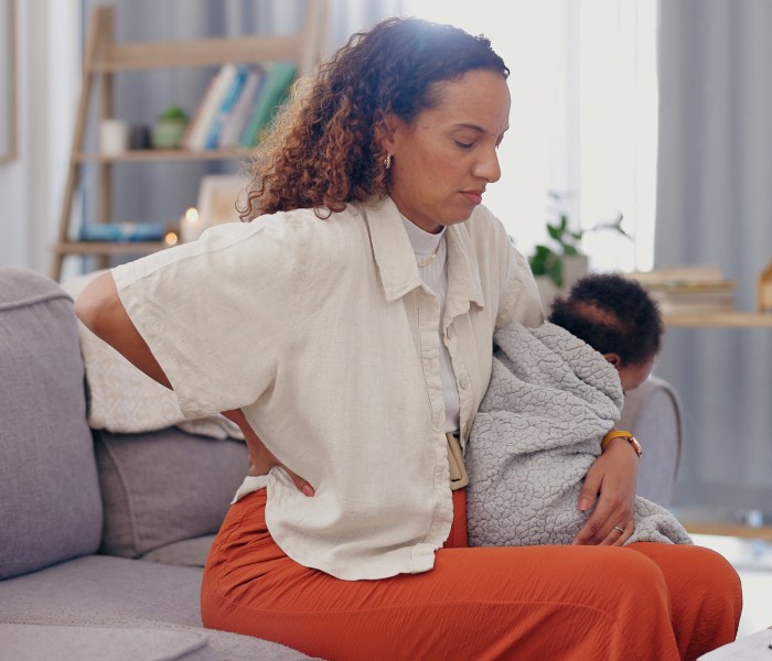 Mother with baby suffering from lower backpain due to Epidural Injections