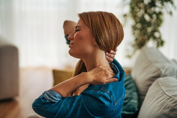 Woman suffering from neck pain