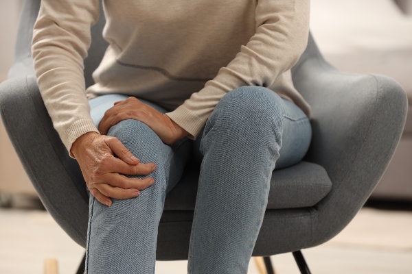 Woman holding knee in pain