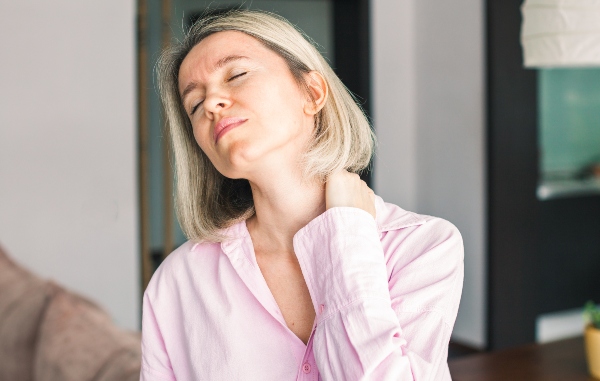 Woman clutching neck in pain