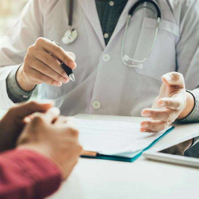 shot of doctor's hands talking to patient