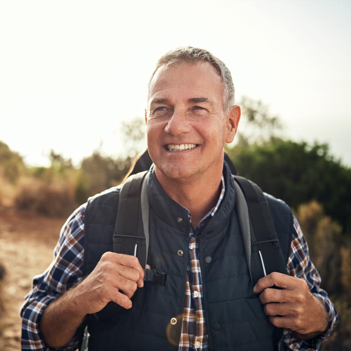 A man hiking on hills after a successful pain relief treatment in Maryland