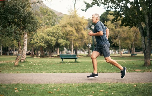 An older man runs through a park in Maryland to keep an active lifestyle.