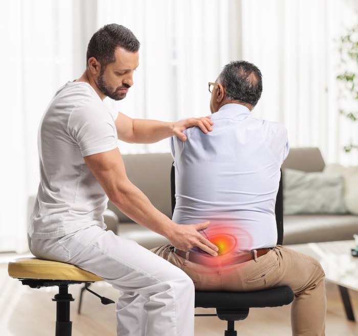 Chiropractor treating a man with lower backpain in Maryland