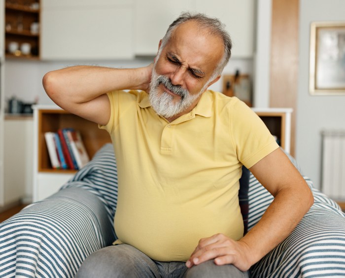 Older Man experiencing neck pain due to pinched nerve in Maryland