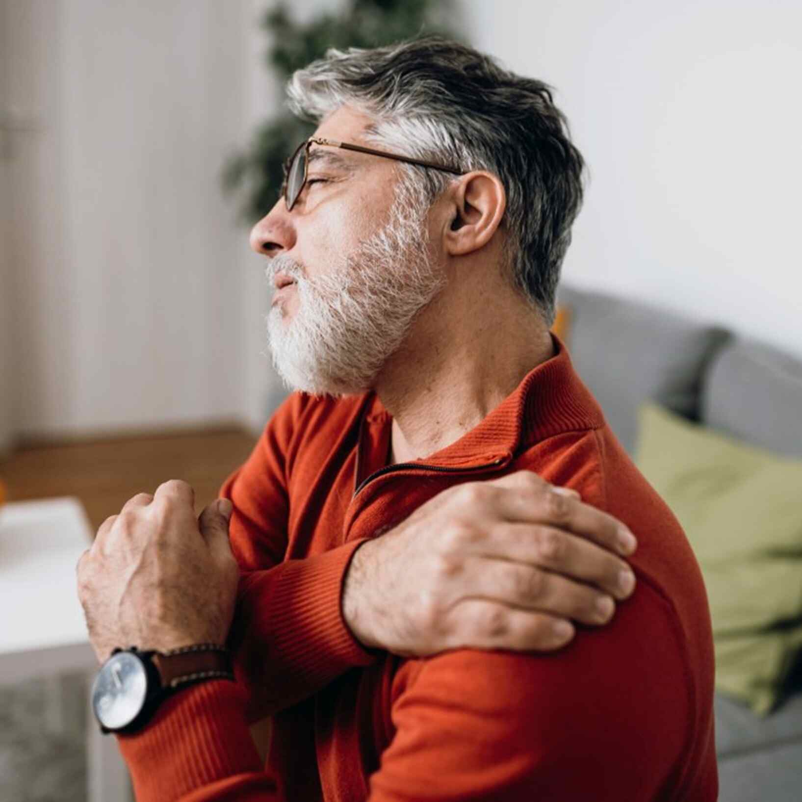 A man experiencing joint & muscle pain at his home in Maryland