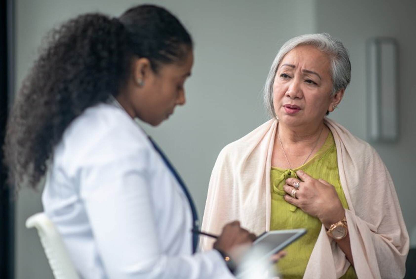 Senior patient complaining of chest pain to the doctor in Maryland