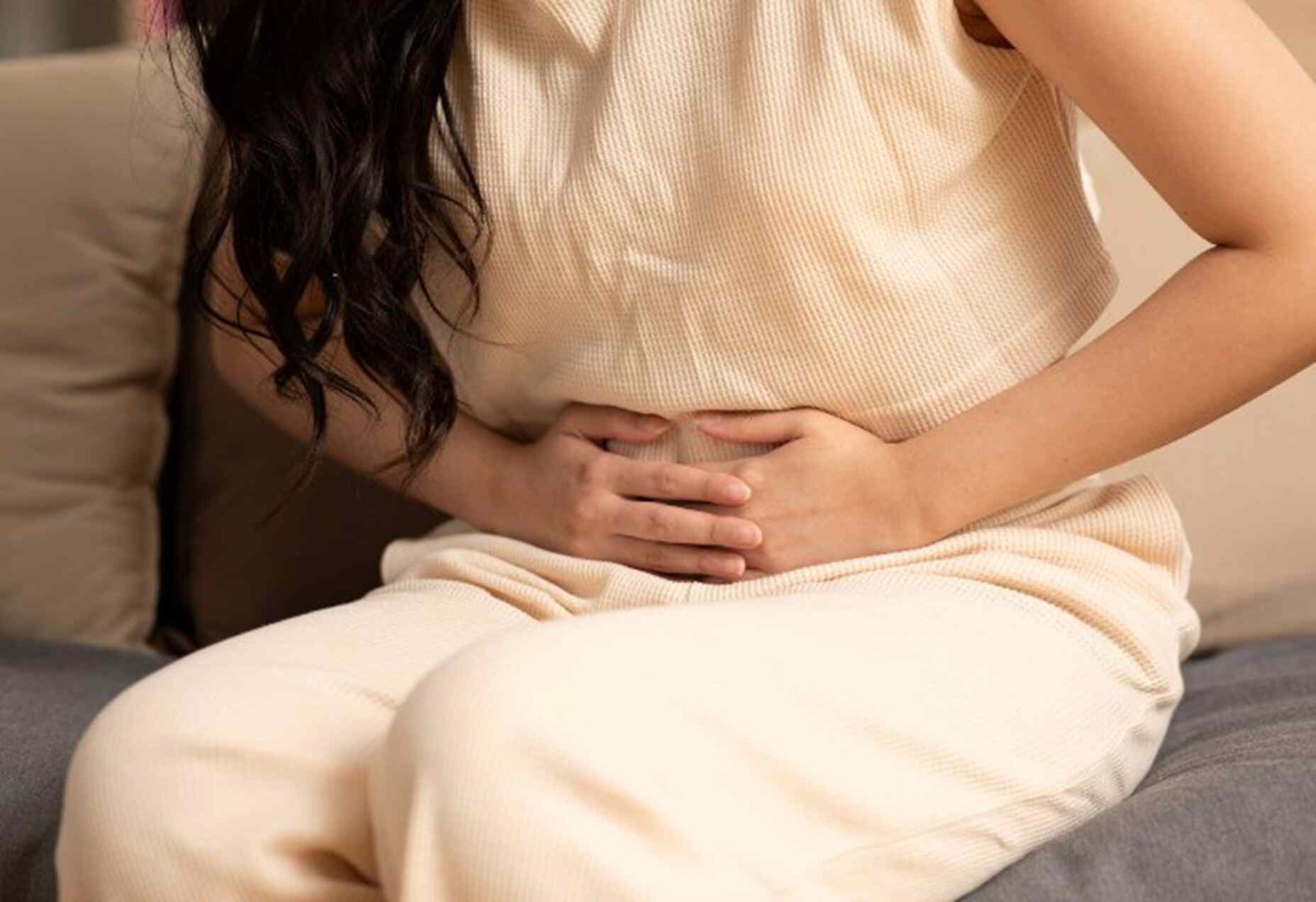 A woman experiencing severe pelvic pain at her home in Maryland